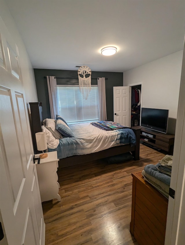 bedroom with dark hardwood / wood-style flooring