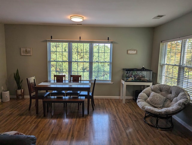 dining space with dark hardwood / wood-style floors and plenty of natural light