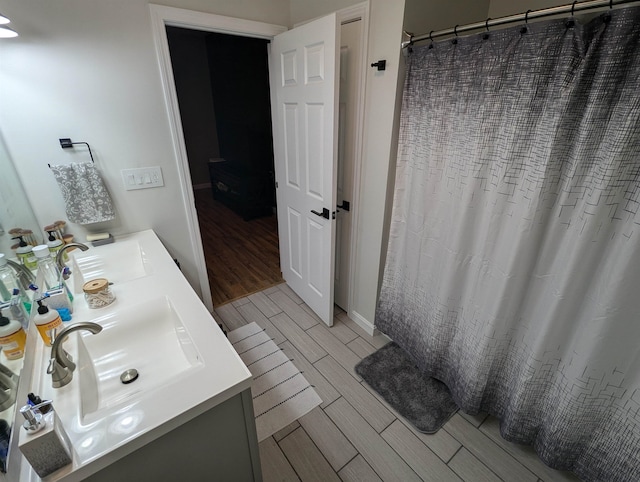 bathroom featuring vanity, hardwood / wood-style floors, and a shower with curtain