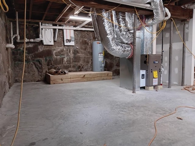 basement with electric water heater and heating unit