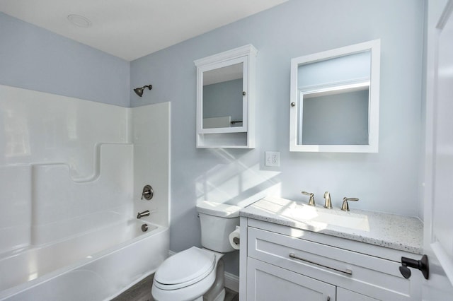 full bathroom featuring bathing tub / shower combination, vanity, and toilet