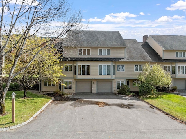 view of front facade with a front yard and a garage