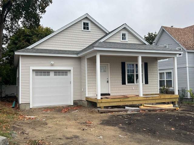 view of front of house featuring covered porch and a garage