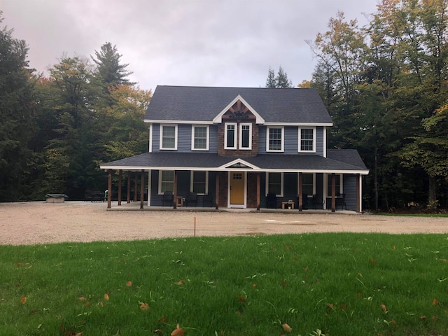 view of front facade featuring covered porch and a front yard