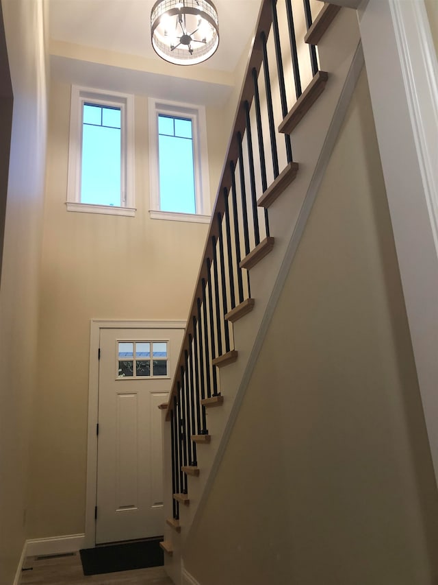 entryway featuring wood-type flooring and an inviting chandelier