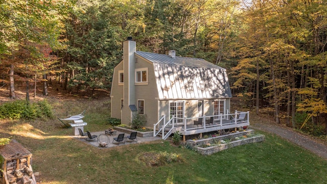 view of outdoor structure featuring a lawn and a fire pit