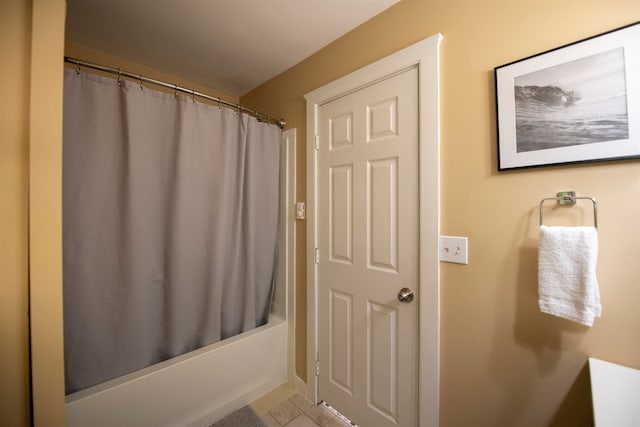 bathroom with shower / tub combo with curtain and tile patterned flooring