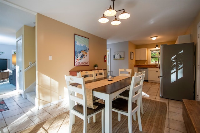 tiled dining area with a notable chandelier and sink