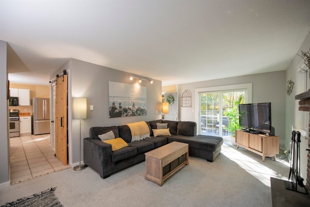 living room featuring a barn door and light carpet