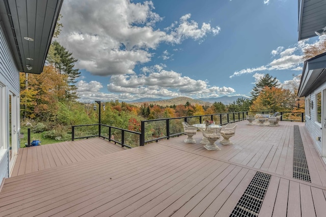 wooden deck with a mountain view