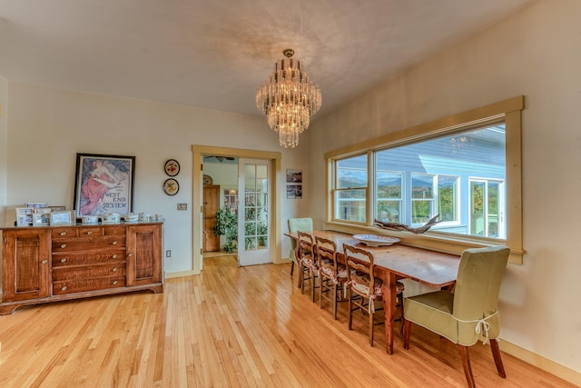 dining space with a chandelier and light hardwood / wood-style floors