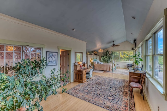 interior space featuring ceiling fan, light hardwood / wood-style floors, and vaulted ceiling