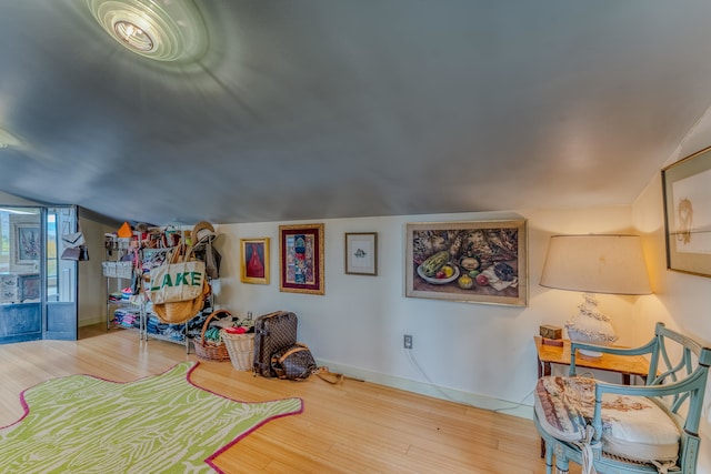 game room with vaulted ceiling and light hardwood / wood-style flooring