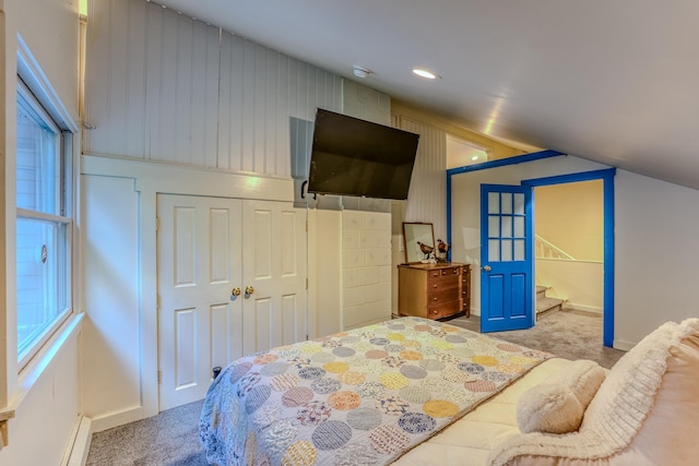 carpeted bedroom featuring a closet and a baseboard radiator