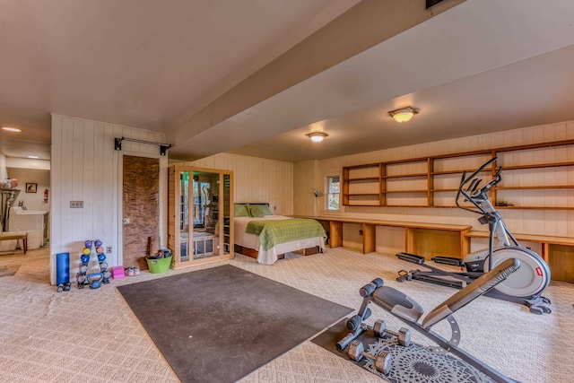 bedroom with wooden walls and carpet floors