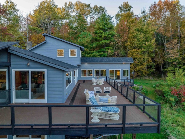 back of property with outdoor lounge area and a deck