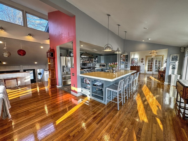 428 Pearl Lake Rd, Sugar Hill, NH 03586 - kitchen featuring stainless steel appliances, open shelves, dark wood-style flooring, high vaulted ceiling, and pendant lighting