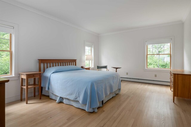 bedroom with multiple windows, a baseboard radiator, and ornamental molding