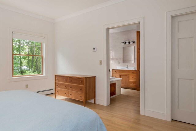 bedroom with sink, connected bathroom, light hardwood / wood-style floors, ornamental molding, and a baseboard radiator