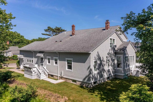 rear view of house with a yard