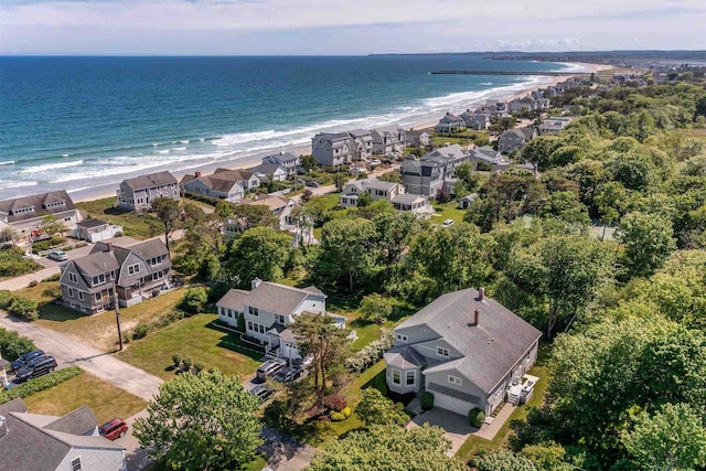 birds eye view of property with a water view and a beach view