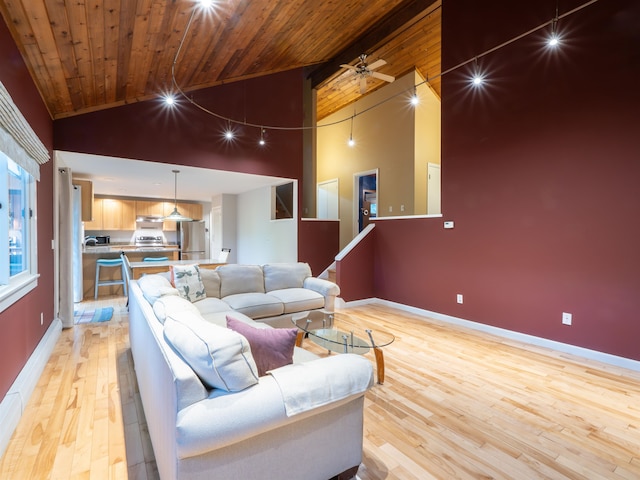 living room with ceiling fan, light wood-type flooring, high vaulted ceiling, and wooden ceiling