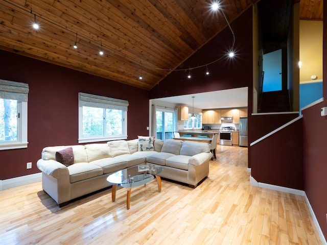 living room featuring track lighting, light wood-type flooring, wood ceiling, and high vaulted ceiling