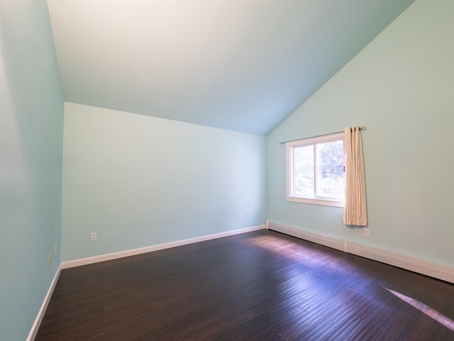 additional living space featuring lofted ceiling and dark hardwood / wood-style floors