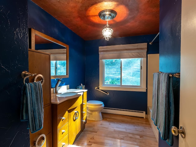 full bathroom featuring hardwood / wood-style floors, plenty of natural light, vanity, and toilet