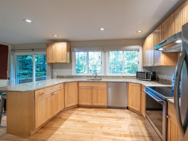 kitchen with light hardwood / wood-style floors, kitchen peninsula, light brown cabinets, stainless steel appliances, and sink