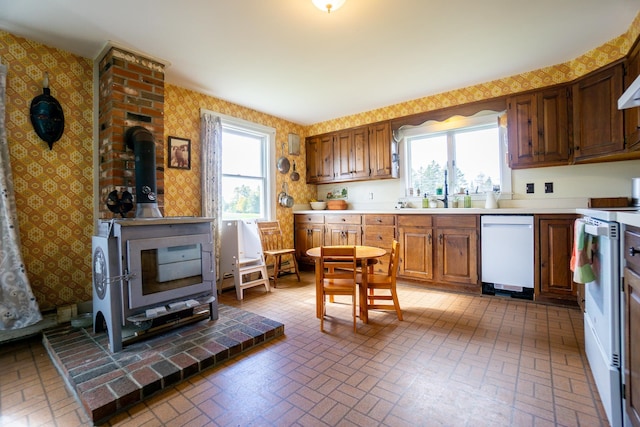 kitchen featuring sink, white appliances, and a wealth of natural light