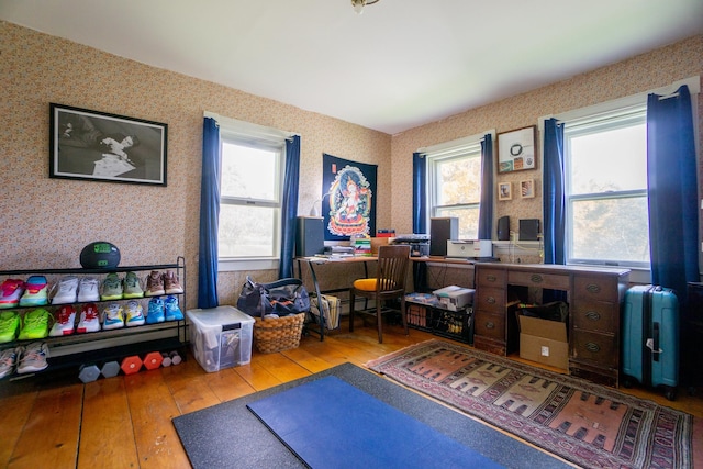 home office with light hardwood / wood-style floors