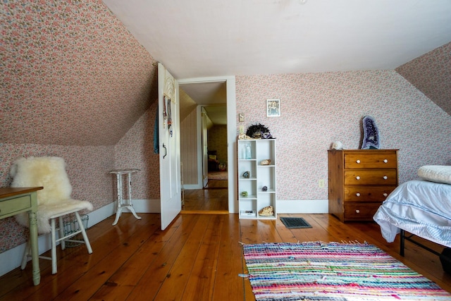 bedroom featuring lofted ceiling and hardwood / wood-style flooring