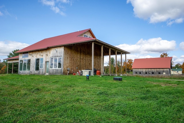 rear view of house with a yard