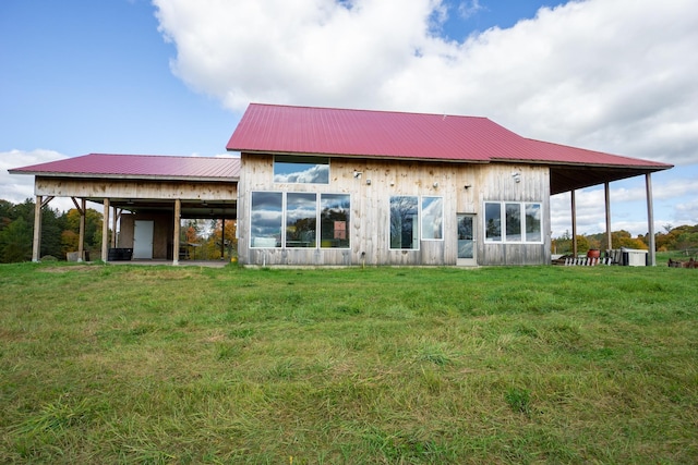 rear view of property with a lawn