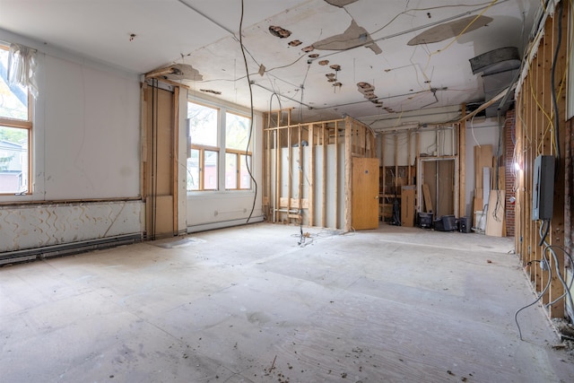 misc room featuring baseboard heating and a wealth of natural light