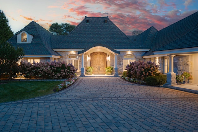 french country home featuring a yard