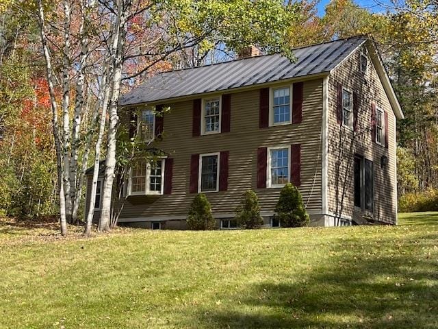 view of property exterior featuring a lawn