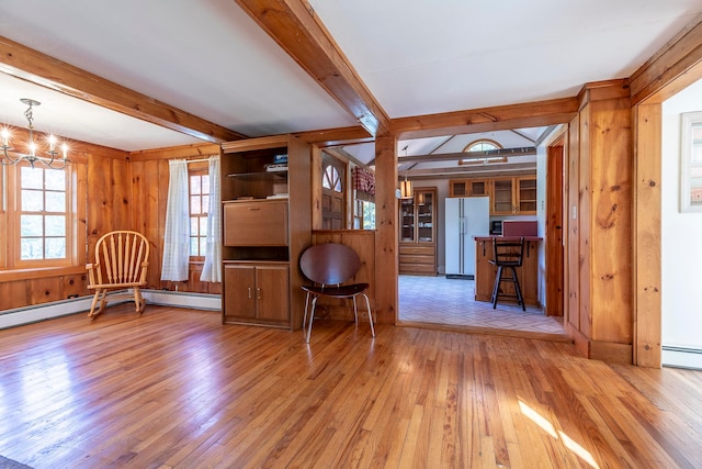 interior space featuring wood walls, light hardwood / wood-style flooring, beamed ceiling, and a notable chandelier