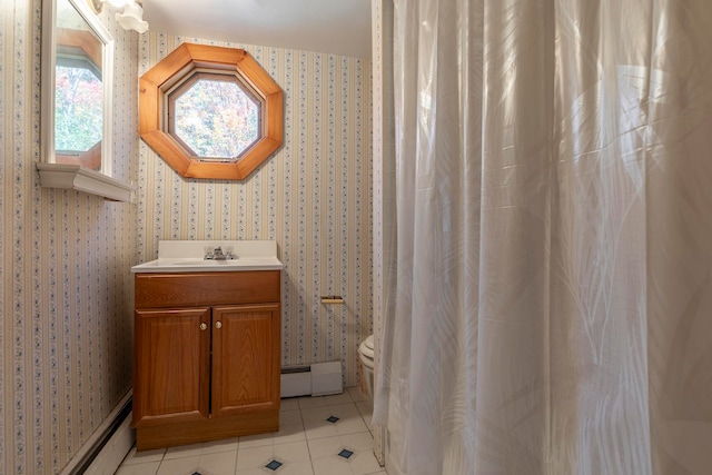 bathroom with toilet, tile patterned flooring, vanity, and a baseboard heating unit