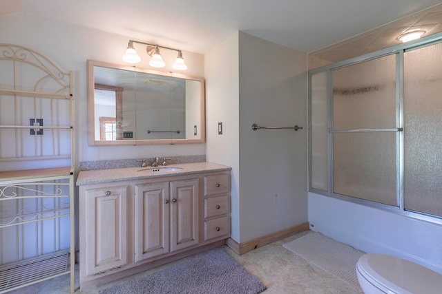 full bathroom with shower / bath combination with glass door, vanity, and toilet