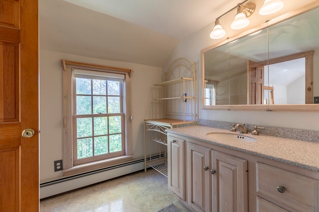 bathroom with vanity, a baseboard radiator, and lofted ceiling