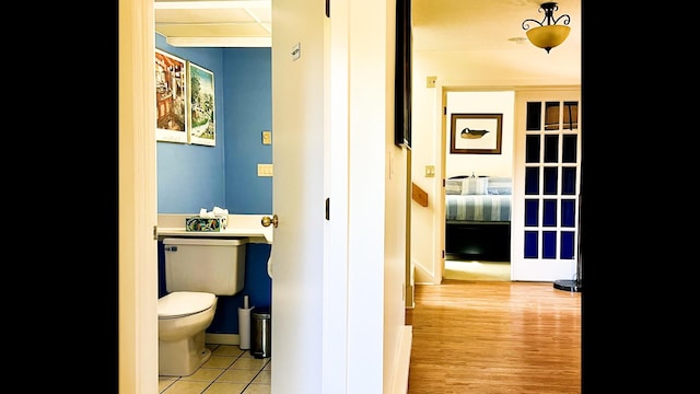 bathroom featuring hardwood / wood-style flooring and toilet