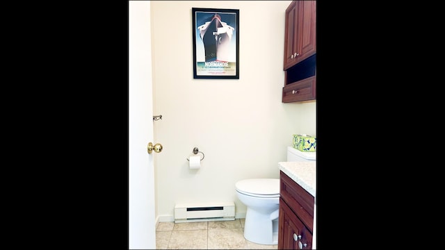 bathroom featuring vanity, baseboard heating, toilet, and tile patterned floors