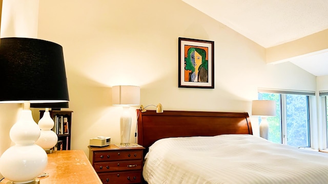 bedroom featuring access to outside and vaulted ceiling with beams