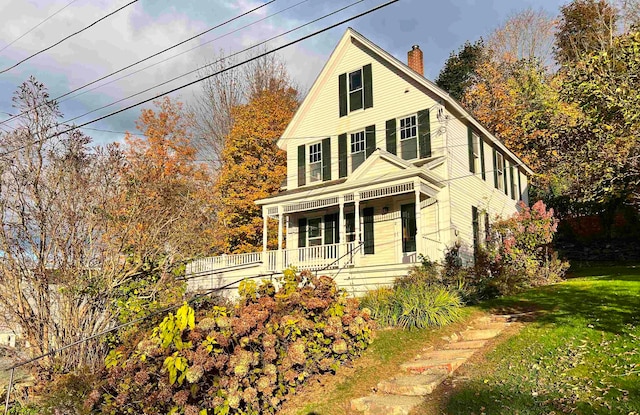 view of front of home with a front lawn and covered porch