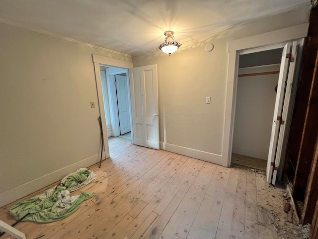 unfurnished bedroom featuring a closet and light hardwood / wood-style floors