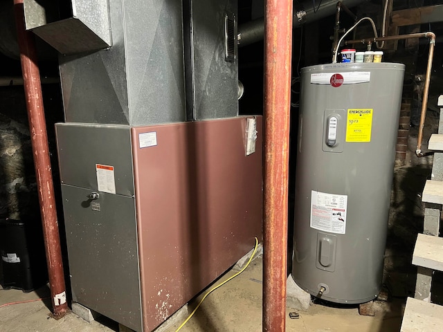 utility room featuring water heater and heating unit