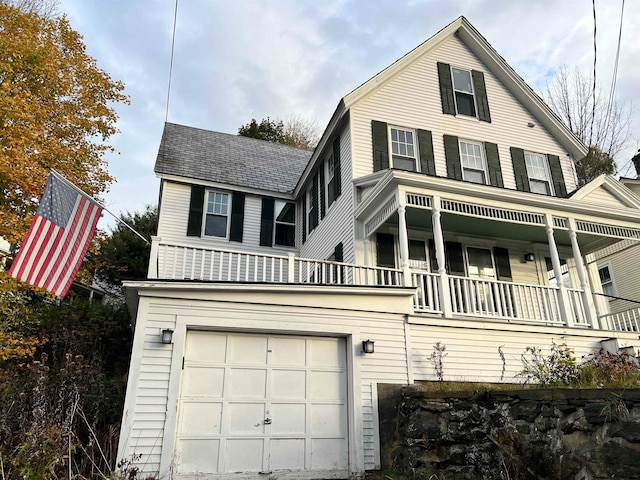 view of front facade featuring a garage and a balcony