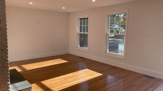 empty room with dark wood-type flooring